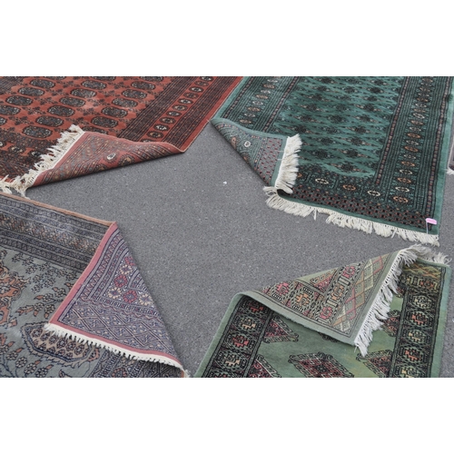 846 - A collection of five bokhara small proportioned Persian manner floor rugs. Each rug being of varied ... 