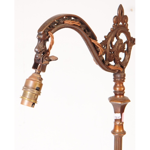 869 - A early 20th century brass Art Nouveau floor standing lamp light. With scrolled ornate detail arm, o... 