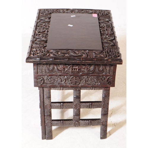 872 - A 19th Century Chinese ebonised hardwood Scholar's writing desk table. Having carved detailing depic... 