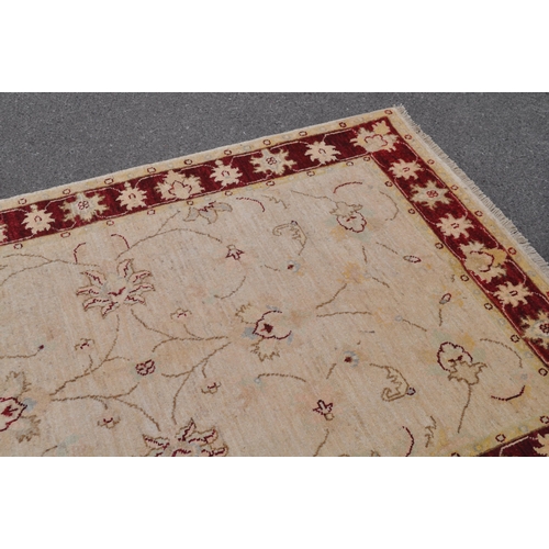 888 - A mid 20th century Persian Ziegler manner carpet rug. The rug having a cream ground with floral scro... 