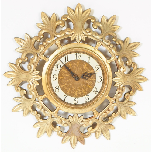 890 - A retro mid 20th century Syroco rococo style gilt wall clock. Syroco to front with ebonised chapter ... 