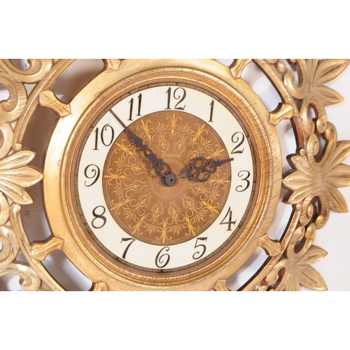 890 - A retro mid 20th century Syroco rococo style gilt wall clock. Syroco to front with ebonised chapter ... 