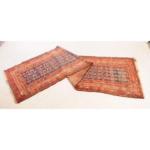 892 - A 20th century Persian runner carpet rug. The rug having a dark blue central field populated with po... 