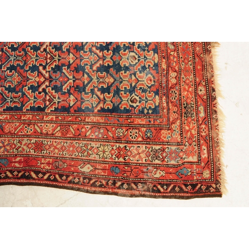 892 - A 20th century Persian runner carpet rug. The rug having a dark blue central field populated with po... 