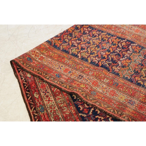 892 - A 20th century Persian runner carpet rug. The rug having a dark blue central field populated with po... 