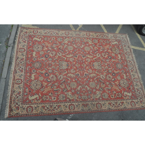 893 - A 20th century Persian manner carpet rug. The rug having a red ground, with a central field populate... 