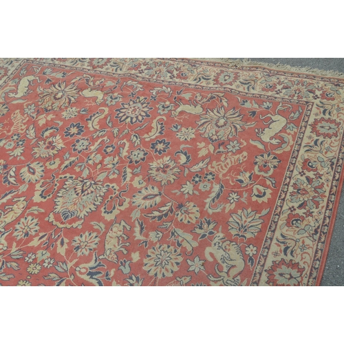 893 - A 20th century Persian manner carpet rug. The rug having a red ground, with a central field populate... 