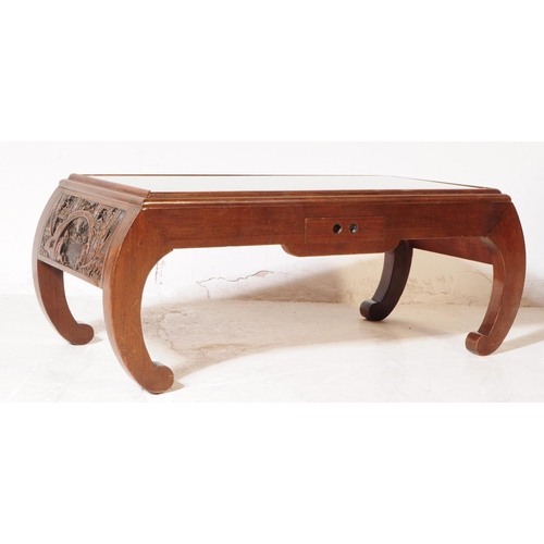 897 - A vintage 20th century hand carved Chinese camphor wood coffee table. Having curved pierced supports... 