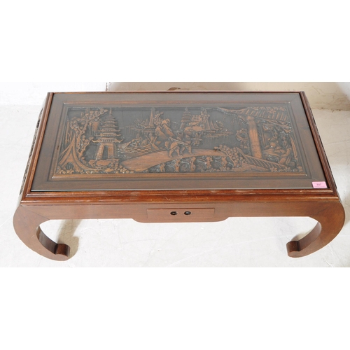 897 - A vintage 20th century hand carved Chinese camphor wood coffee table. Having curved pierced supports... 