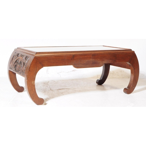 897 - A vintage 20th century hand carved Chinese camphor wood coffee table. Having curved pierced supports... 