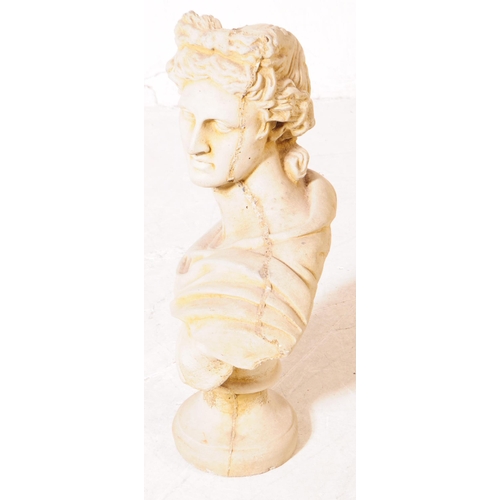 917 - A stone composite bust of Apollo. The bust raised on a rounded plinth, with upper torso and shoulder... 