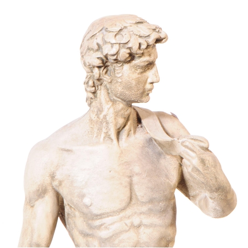 918 - A cast stone composite garden figure statue of Michelangelo's David. The figure stood upon a natural... 