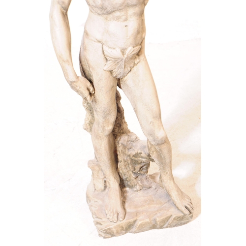 918 - A cast stone composite garden figure statue of Michelangelo's David. The figure stood upon a natural... 