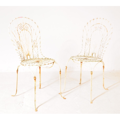 920 - A pair of vintage 20th century wire work metal garden outdoor chairs. Having curved backrest pierced... 