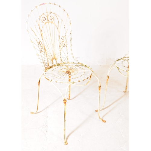 920 - A pair of vintage 20th century wire work metal garden outdoor chairs. Having curved backrest pierced... 