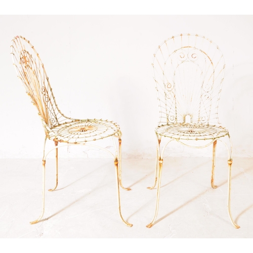 920 - A pair of vintage 20th century wire work metal garden outdoor chairs. Having curved backrest pierced... 