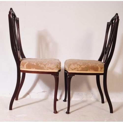 922 - A set of four Edwardian mahogany Hepplewhite dining chairs. With pierced shield back backrest on dam... 