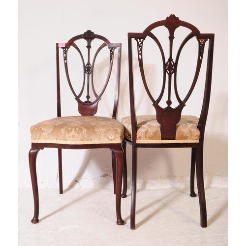 922 - A set of four Edwardian mahogany Hepplewhite dining chairs. With pierced shield back backrest on dam... 