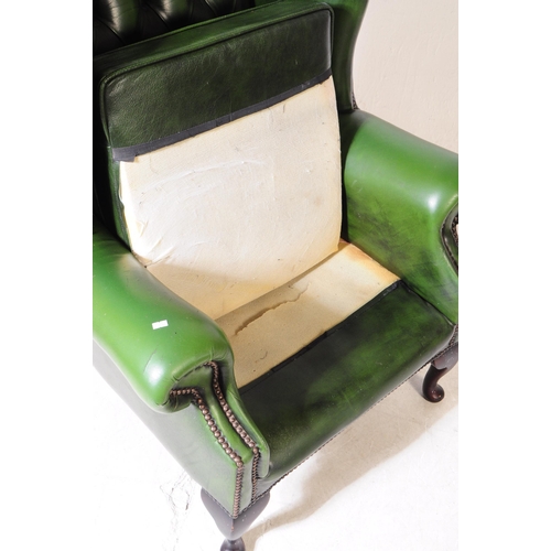 930 - Chesterfield style - A 20th Century green leather Chesterfield manner wingback armchair. Raised on c... 