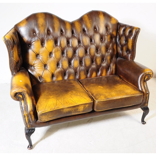 935 - Chesterfield style - A 20th Century yellow leather Chesterfield manner wingback two seater sofa love... 