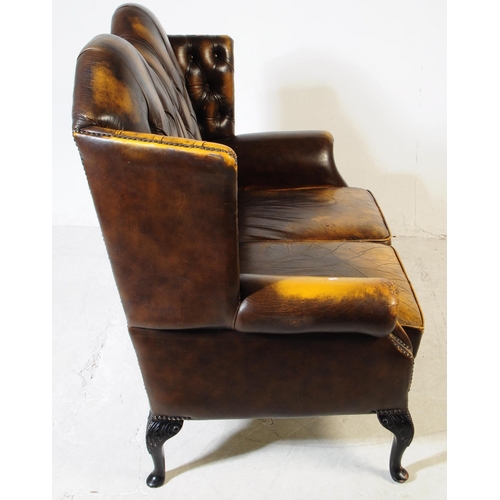 935 - Chesterfield style - A 20th Century yellow leather Chesterfield manner wingback two seater sofa love... 