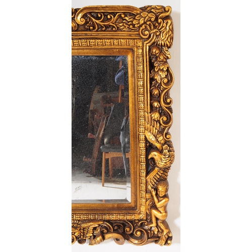 942 - A 20th century Indian manner gilt framed wall mirror. The mirror having carved gilt frame, featuring... 