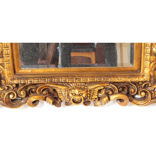 942 - A 20th century Indian manner gilt framed wall mirror. The mirror having carved gilt frame, featuring... 