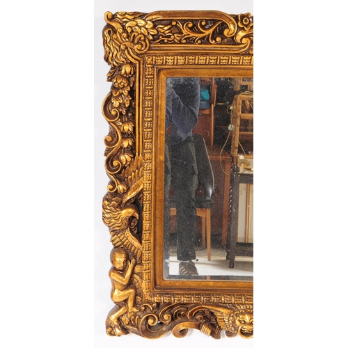 942 - A 20th century Indian manner gilt framed wall mirror. The mirror having carved gilt frame, featuring... 