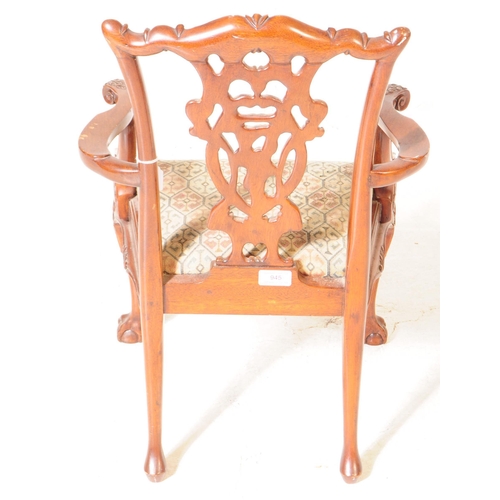 945 - An early 20th century Chippendale revival mahogany childs dining carver armchair. The chair raised o... 