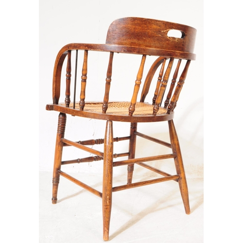 956 - A 19th century Victorian oak and rattan smokers bow captains armchair. The chair raised on rounded s... 