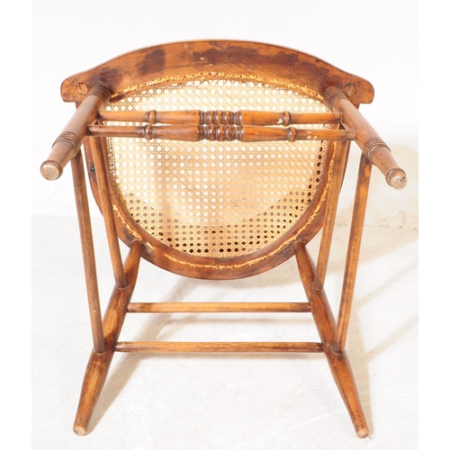 956 - A 19th century Victorian oak and rattan smokers bow captains armchair. The chair raised on rounded s... 