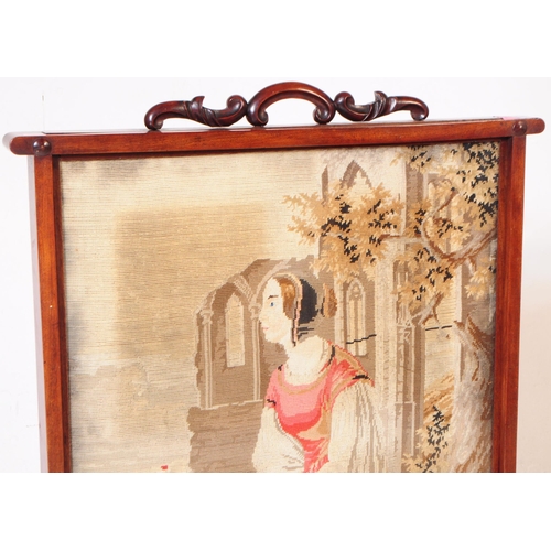 957 - A 19th century Victorian rosewood tapestry firescreen. The screen raised on block feet, joined by a ... 