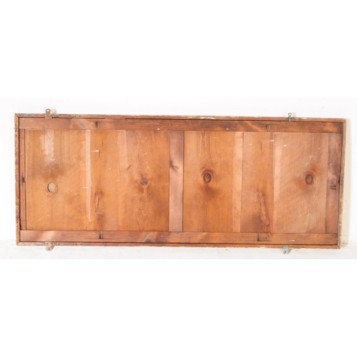 960 - A large 19th century mahogany shop / haberdashery wall mirror. The mirror of rectangular form mounte... 