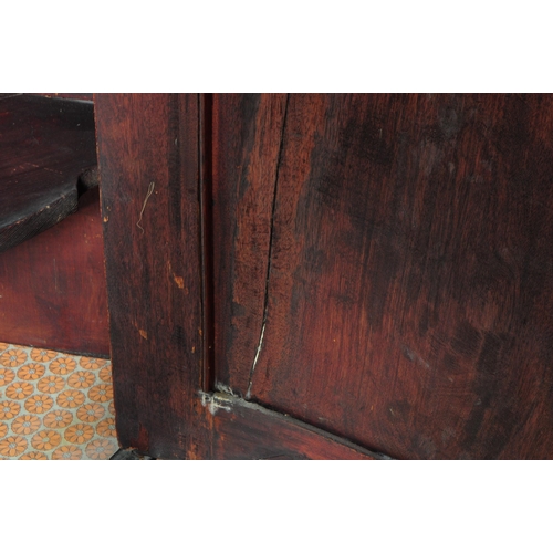 961 - A 19th century Biedermeier corner cabinet. The cabinet raised on stile legs, having a bow fronted do... 