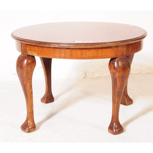 964 - An Edwardian walnut veneer marquetry inlaid low coffee side table. The table of round form, with mar... 