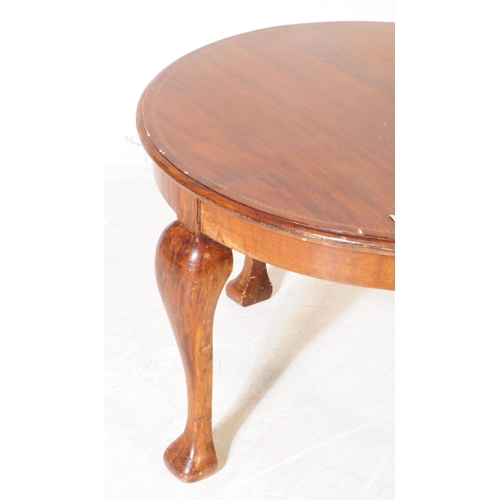 964 - An Edwardian walnut veneer marquetry inlaid low coffee side table. The table of round form, with mar... 