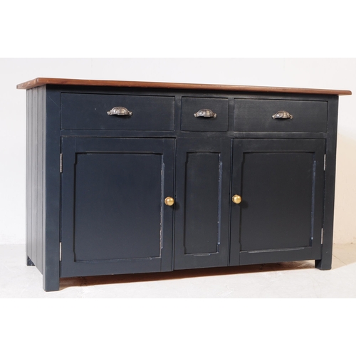 973 - A 20th century painted country pine sideboard. Rectangular form with solid wood top, panel sides and... 