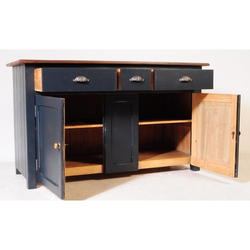 973 - A 20th century painted country pine sideboard. Rectangular form with solid wood top, panel sides and... 