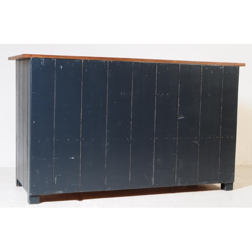 973 - A 20th century painted country pine sideboard. Rectangular form with solid wood top, panel sides and... 