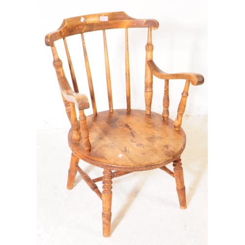 975 - A 20th century farmhouse elm spindle back penny seat Windsor armchair. With stick-back, turned suppo... 