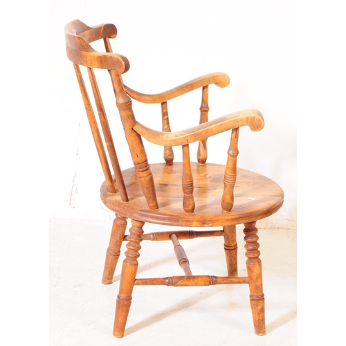 975 - A 20th century farmhouse elm spindle back penny seat Windsor armchair. With stick-back, turned suppo... 