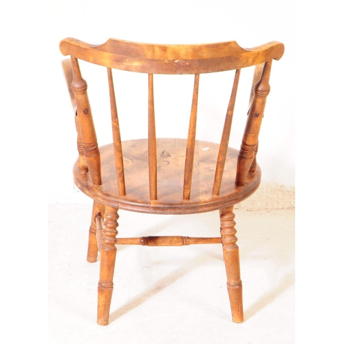 975 - A 20th century farmhouse elm spindle back penny seat Windsor armchair. With stick-back, turned suppo... 