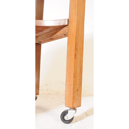 979 - A vintage 20th century oak sewing / side table. With small needle / thread drawer, with gate leg ext... 