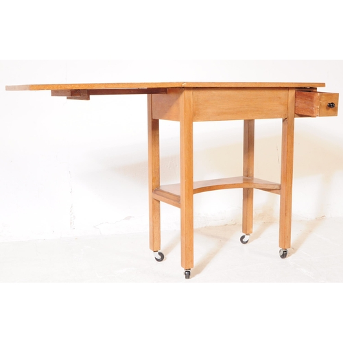 979 - A vintage 20th century oak sewing / side table. With small needle / thread drawer, with gate leg ext... 