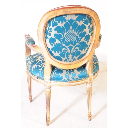 986 - A Louis XVI manner giltwood salon armchair. The chair raised on tapered fluted legs to front, having... 