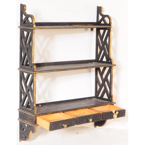 987 - A 20th century Chinoiserie manner wall hanging bookshelf. The bookshelf featuring a row of three car... 