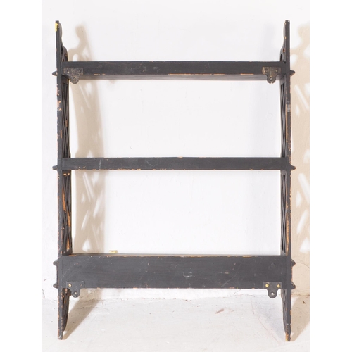 987 - A 20th century Chinoiserie manner wall hanging bookshelf. The bookshelf featuring a row of three car... 