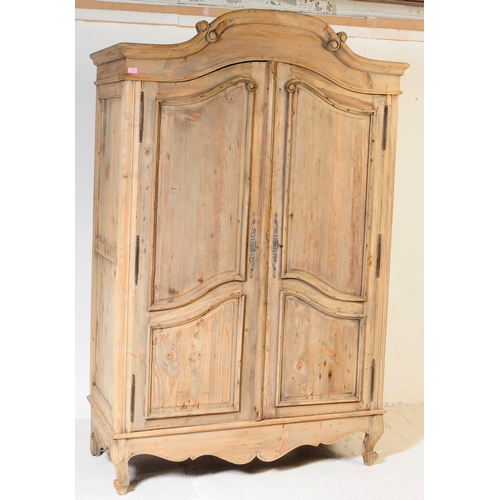 991 - A 20th century Louis XVI revival pine armoire wardrobe. Raised on cabriole legs to front, with a sha... 