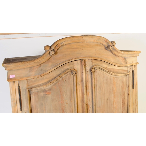 991 - A 20th century Louis XVI revival pine armoire wardrobe. Raised on cabriole legs to front, with a sha... 