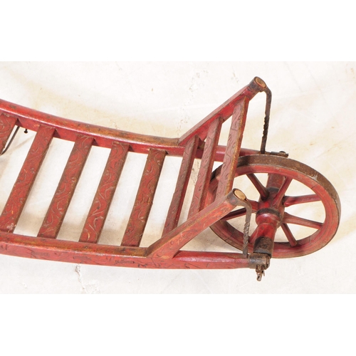 994 - A late 19th century Victorian red lacquered sack barrow. The barrow having a single wheel to front, ... 